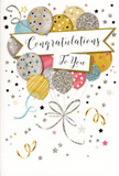 This photograph shows a beautifully designed congratulations card that feels like a compact celebration, ideal for pairing with flowers delivered around Leytonstone. The card's artwork centres on a buoyant gathering of balloons, each illustrated with soft care and arranged in a loose cluster that seems to float upward. The colour palette leans toward gentle metallics and pastels: brushed gold, soft silver, champagne cream, light blue, blush pink, and misty grey. On the surfaces of the balloons, delicate patterns appear-tiny stars scattered like constellations, slender bands of metallic stripes, and hints of glitter that suggest a subtle, sophisticated shimmer, rather than bold sparkle. The balloon ribbons cascade downwards, painted in looping strokes of gold and silver that tangle and twist near the bottom in a relaxed knot, reminiscent of streamers trailing from a party near Leytonstone Overground station. A softly unfurling banner stretches across the centre of the balloon bouquet, supporting the message "Congratulations To You" rendered in flowing, stylish handwriting that carries warmth and sincerity. Surrounding this central composition is a pale, airy background, animated by sprinkled metallic stars, swirling ribbon shapes, and confetti-like dots that add a feeling of lightness and quiet joy. Though only seen, not touched, the surface suggests the richness of quality card stock combined with glossy details and just enough raised texture to feel special. The overall impression is one of graceful celebration-a card that would look perfectly at home nestled among fresh blooms on a mantelpiece in Leytonstone, marking life's proud moments from exam results to new beginnings with a blend of sweetness, elegance, and local charm.